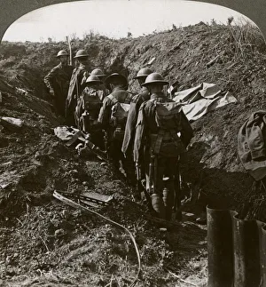 Officer watching his men file into a dug-out to avoid a German strafe, World War I, 1914-1918. Artist: Realistic Travels Publishers