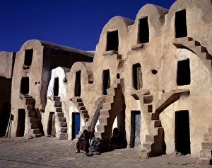 Tunisia Gallery: Old typical barns with people sitting on the stairs