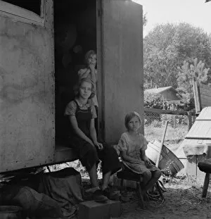 The oldest girl seated in the doorway of the house trailer... Yakima Valley, Washington, 1939. Creator: Dorothea Lange