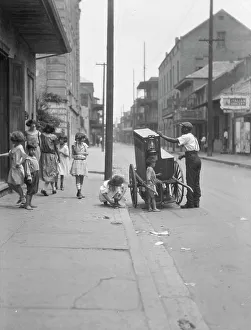 Street Musician Prints: Organ grinder, New Orleans, between 1920 and 1926. Creator: Arnold Genthe