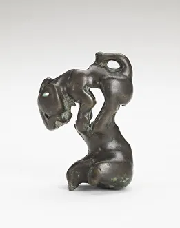 Ornament in the form of a feline-like animal on a foot-shaped stand, Han dynasty
