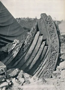 The Oseberg ship in the mound, showing the carving on stem and railing, 1935 The Oseberg ship in the mound, showing the carving on stem and railing, 1935