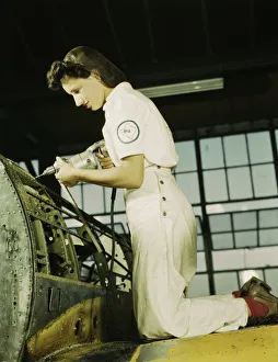 Oyida Peaks riveting as part of her NYA training... Naval Air Base, Corpus Christi, Texas, 1942. Creator: Howard Hollem