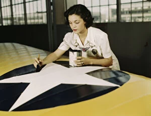 Employment Collection: Painting the American insignia on airplane wings is a job...Air Base, Corpus Christi, Texas, 1942