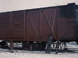Chicago And North Western Railway Gallery: Painting a car at the repair or 'rip'tracks at North Proviso(?), C & NW RR, Chicago, Ill. 1942
