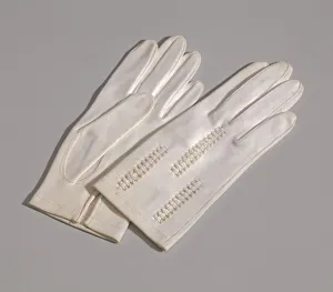 Pair of light cream gloves with openwork design from Mae's Millinery Shop, 1941-1994 Pair of light cream gloves with openwork design from Mae's Millinery Shop, 1941-1994