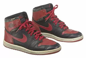 Logo Gallery: Pair of red and black Air Jordan I high top sneakers made by Nike, 1985. Creator: Nike