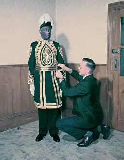 Commonwealth Prints: A Paramount Chief being fitted for his robes for the coronation of Queen Elizabeth II