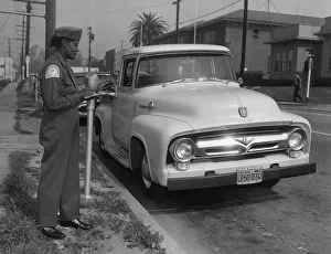 Ford Prints: Parking meter with Los Angeles parking control officer 1958. Creator: Unknown