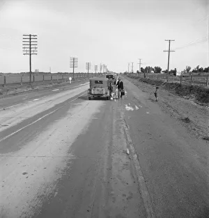 Passing motorist gives walking family of seven a lift to the next town, California, 1939. Creator: Dorothea Lange Passing motorist gives walking family of seven a lift to the next town, California, 1939. Creator: Dorothea Lange