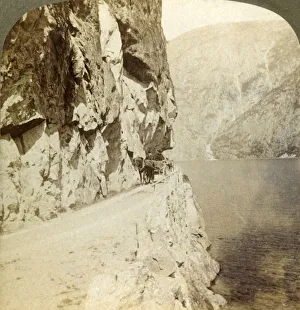 Path blasted out of the towering cliffs for a road around Oifjords Lake, Norway, 1905 Path blasted out of the towering cliffs for a road around Oifjords Lake, Norway, 1905