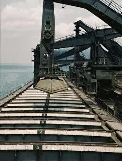 Pennsylvania R.R. iron ore docks, unloading ore from a lake freighter...ore unloaders, 1943. Creator: Jack Delano