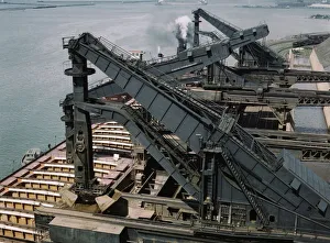 Pennsylvania R.R. ore docks, unloading iron ore from a lake freighter... Cleveland, Ohio, 1943. Creator: Jack Delano