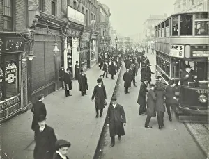 Trolley Bus Prints: People rushing to get on a trolley bus at 7. 05 am, Tooting Broadway, London, April 1912