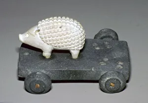 Persian hedgehog mounted on a wheeled carriage
