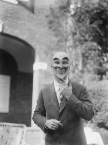 Joker Prints: Person wearing a mask made by W.T. Benda, 1925 Sept. 20. Creator: Arnold Genthe