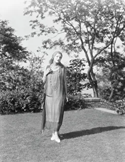 Person wearing a mask made by W.T. Benda, 1925 Sept. 20. Creator: Arnold Genthe