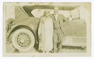 Portraits Gallery: Photograph of a man and woman in front of car, ca. 1921. Creator: Unknown