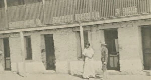 Photograph of a man and woman standing on a sidewalk, early 20th century
