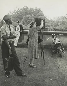 Gilded Age Prints: Photographer Frances Benjamin Johnston standing beside her view camera preparing to take