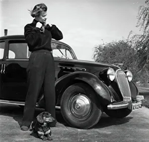 Nordic Museum Prints: Photographer Kerstin Bernhard stands next to a car with her dachshund