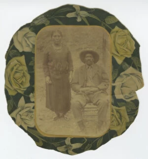 Portraits Gallery: Photographic portrait of a man and woman on floral paper backing, early 20th century