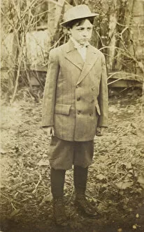 Portraits Gallery: Photographic postcard of a boy wearing a double-breasted jacket and breeches