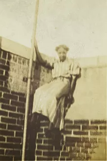 Gelatin Silver Prints Collection: Photographic print of a woman on a brick wall, early 20th century. Creator: Unknown