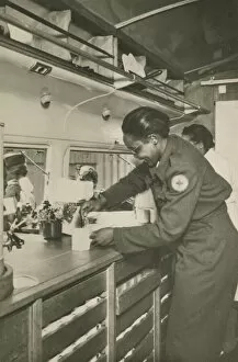 Picture postcard of a volunteer serving troops out of a Red Cross “Clubmobile"