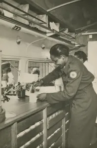 Mobile Prints: Picture postcard of a volunteer serving troops out of a Red Cross Clubmobile