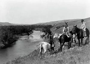 Blackfeet Prints: Three Piegan Indians and four horses on hill above river