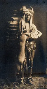 Curtis Prints: A Piegan man, Iron Breast, in ceremonial dress, 1900. Creator: Edward Sheriff Curtis