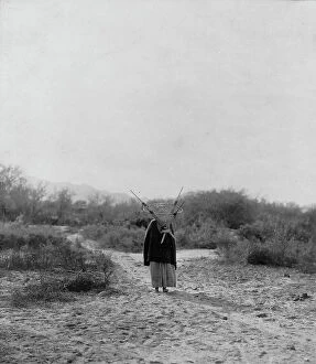 Basket Collection: Pima woman, with burden basket on back, walking away from camera, Pima, Arizona, c1907