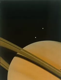 Shoot for the Moon Collection: The planet Saturn with moons Tethys and Dione. Creator: NASA