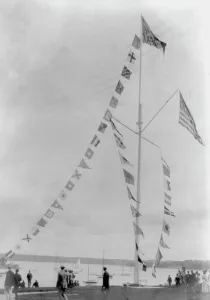 Pole with flags of different countries; sailboats in background, Oyster Bay, Long Island, N.Y. 1905 Creator: Frances Benjamin Johnston