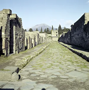 A Pompeii street with Vesuvius in the distance, Italy