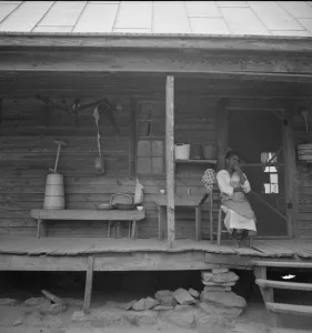 Tenants Prints: Porch of Negro tenant house, showing household equipment