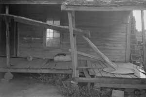 Dilapidated Prints: Porch of a sharecroppers cabin, Hale County, Alabama, 1936. Creator: Walker Evans