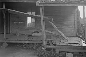 Derelict Gallery: Porch of a sharecroppers cabin, Hale County, Alabama, 1936. Creator: Walker Evans