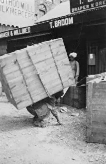 Chakrata Gallery: A porter lifting a large load, Chakrata, India, 1917