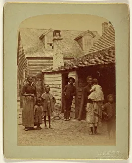 Card Photograph Prints: Portrait of a Black family standing in front of a house, 1886. Creator: George Barker