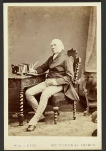 Woodcarving Prints: Portrait of man holding quill, about 1879-1885. Creator: Maull & Fox