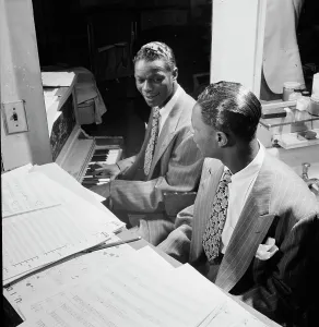 Arranging Prints: Portrait of Nat King Cole, New York, N.Y. ca. June 1947. Creator: William Paul Gottlieb