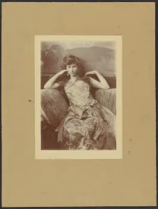 Sofa Prints: Portrait of seated woman, 1900-1910. Creator: Constant Puyo