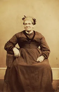 Headwrap Prints: Portrait of seated woman wearing a headwrap, c1870. Creator: Thomas M Saurman