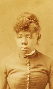 Portrait of unidentified young woman with buttoned bodice and band collar, (1880-1889?). Creator: H. A. Insley