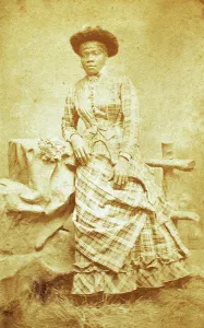 Plaid Prints: Portrait of unidentified young woman in plaid dress and hat