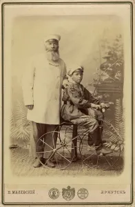 Hand On Shoulder Prints: Portrait of an unknown man with a boy sitting on a bicycle
