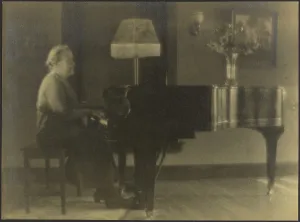 Piano Stool Prints: Portrait of a Woman Seated at the Piano, 1895-1907. Creator: Louis Fleckenstein