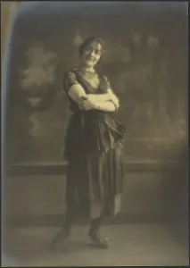 Portrait of a Woman Standing Before Tapestry, 1907-1943. Creator: Louis Fleckenstein